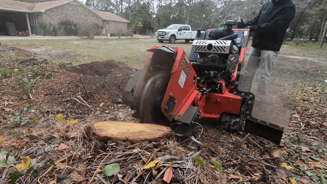 Tree Service man using a tree stump grinder